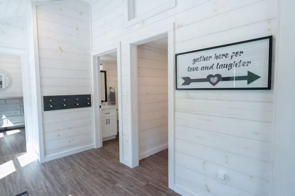 Hallway leading to 2 rooms and a bathroom