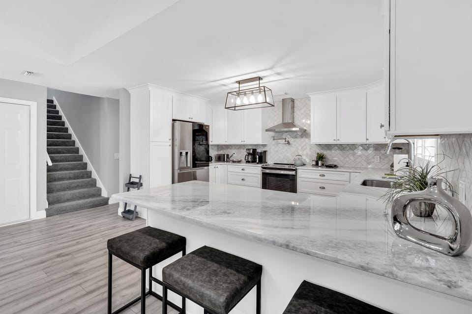 Countertop bar area and stairs leading to the second level
