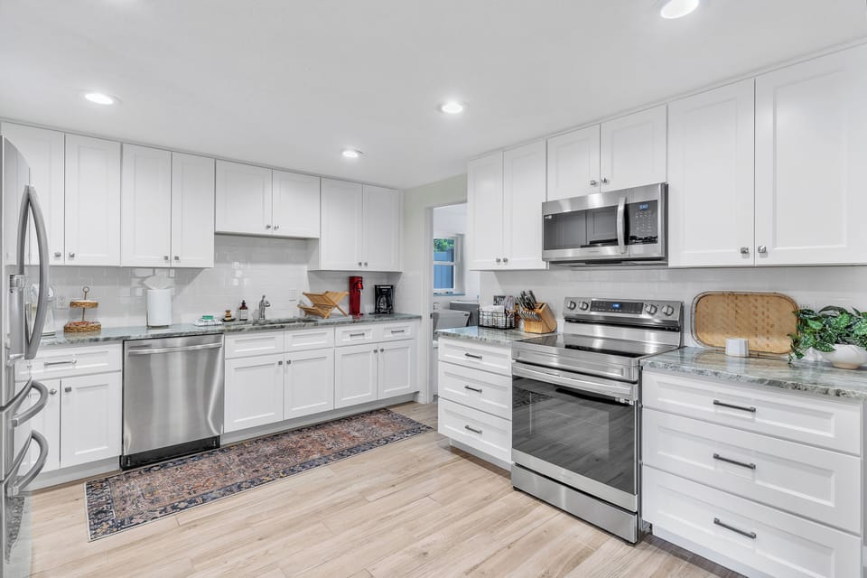 The kitchen is an open space with lots of countertop room for you to prepare meals on. The dishwasher helps make clean up a breeze!