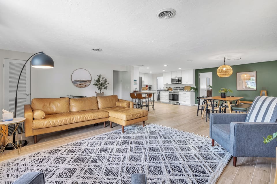 The living room is a comfortable space with a 3-seater couch and two chairs.