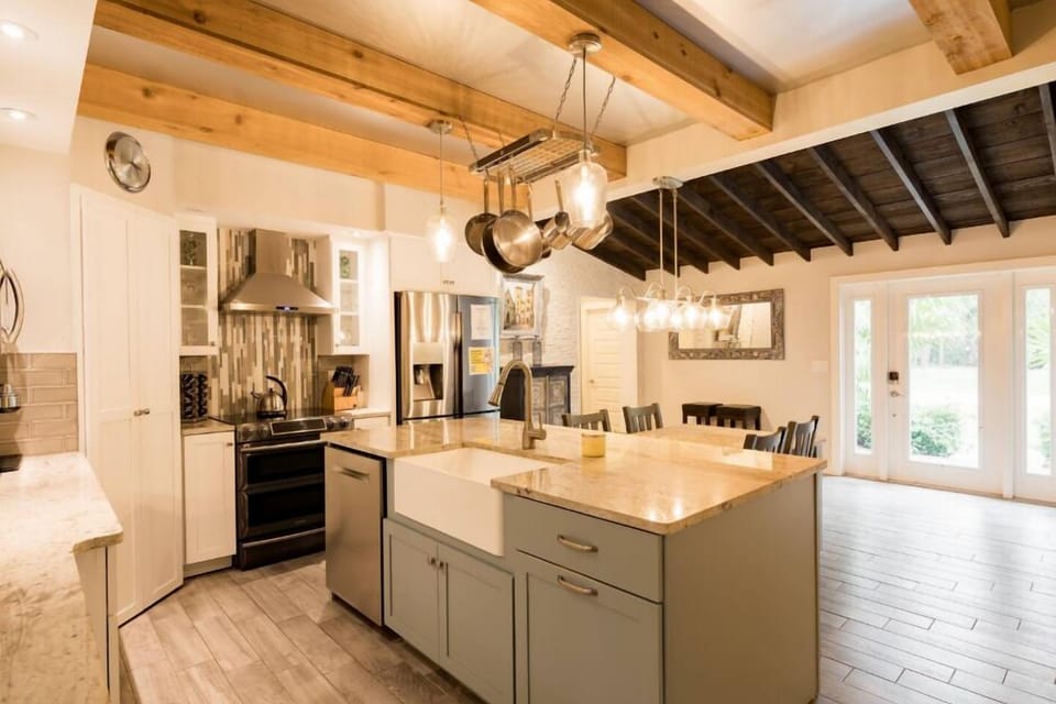 Beautiful fully stocked kitchen with and island that has the kitchen sink and dishwasher and an attached dining table!