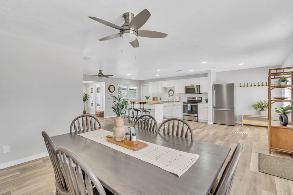 Seamlessly connected, the dining area extends into a modern kitchen, fostering an open, airy feel. The adjoining space allows conversations to flow as delicious scents mingle with the warmth of shared meals.