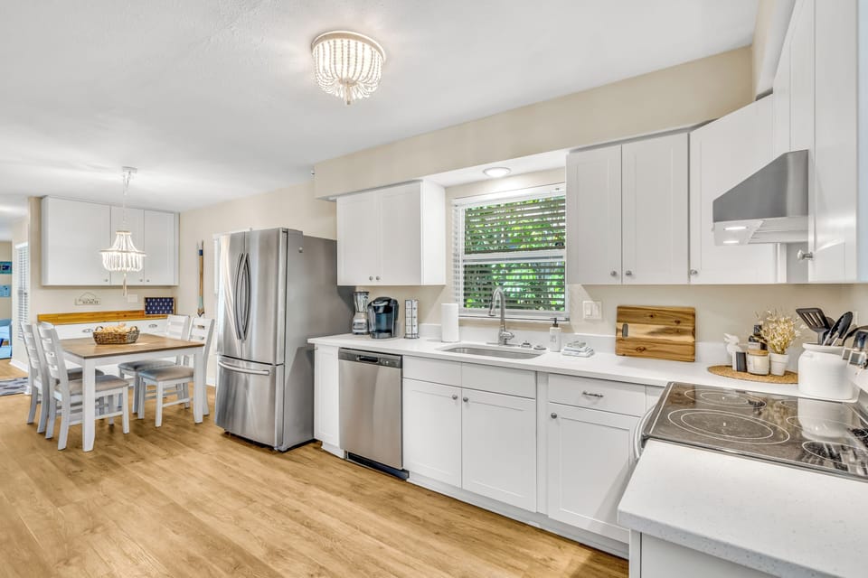 The kitchen comes equipped with a stainless-steel fridge with double doors and a pull-out freezer, dishwasher, Keurig coffee maker, and more.