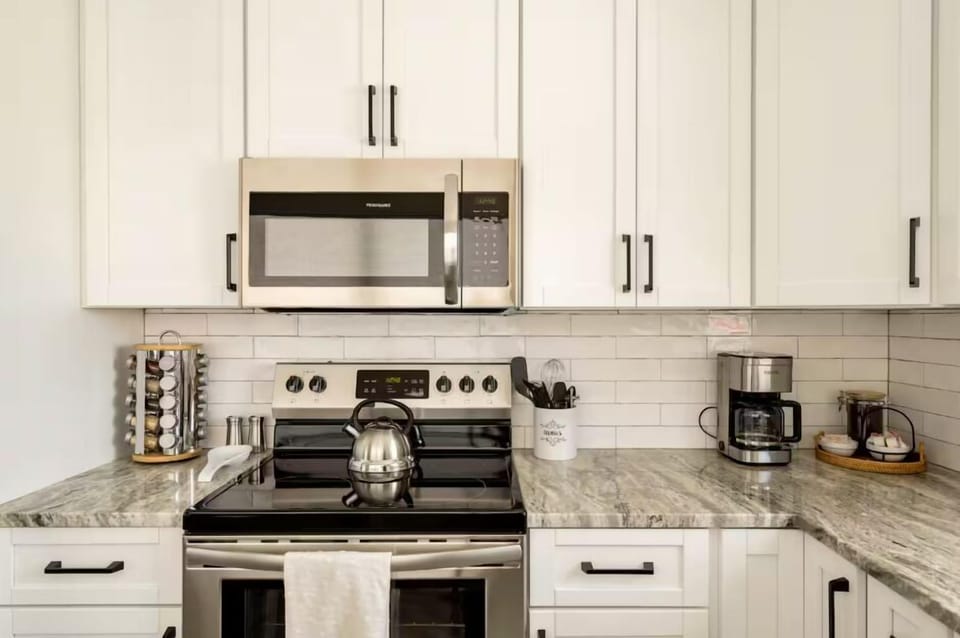 Make yourself at home in this kitchen! There is an electric stove and other amenities like a coffee maker and water kettle.