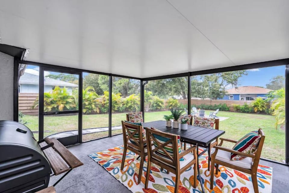 A backyard patio oasis with an outdoor table for al fresco dining and a charcoal grill for sizzling BBQs. Perfect for gatherings and evenings.