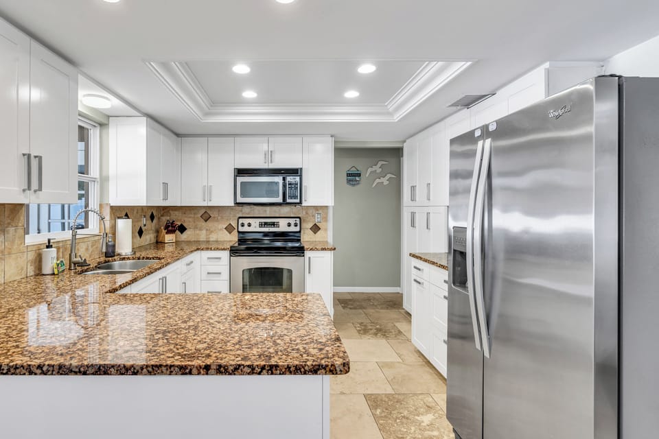 The kitchen has all you need to feel right at home! Featuring a full-size refrigerator, electric stove, microwave, and a dishwasher.