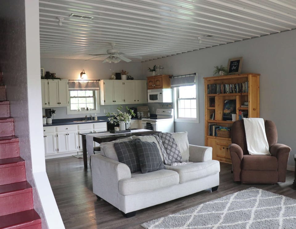 Love seat couch and a lazy boy chair. Prepare your meals in the kitchen and you can still be around the others with the nice open floor space between rooms.