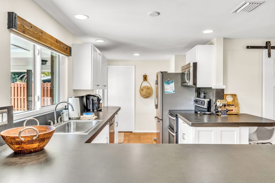 Kitchen space with Keurig, dishwasher, oven, and microwave.