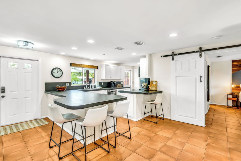 Kitchen space with open countertops and seating.