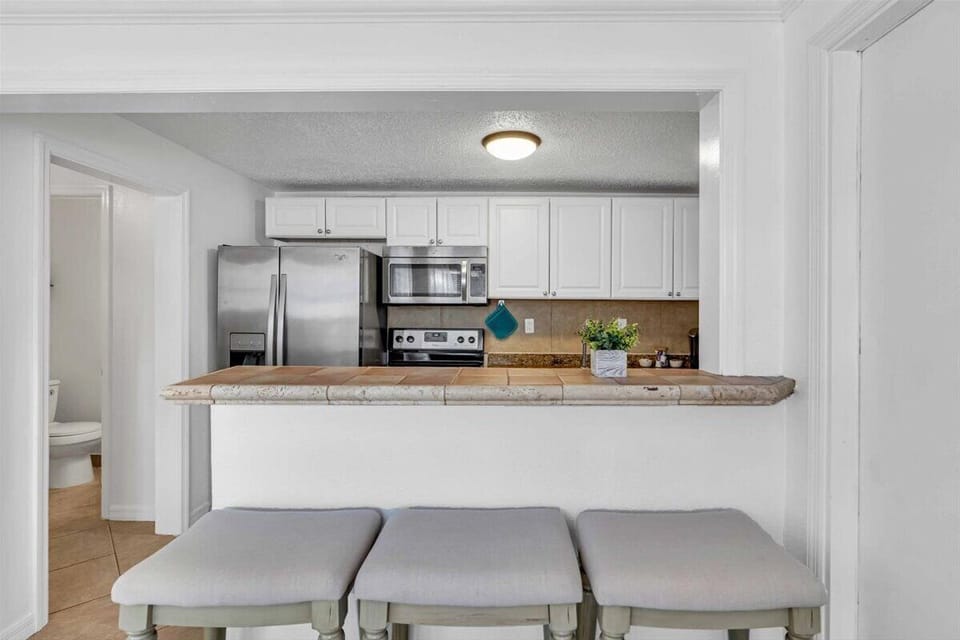 The countertop bar has 3 seats, a perfect spot to grab a quick bite to eat