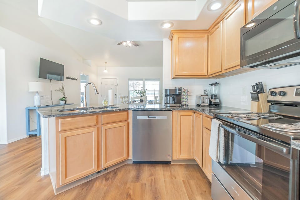 Sink & Dishwasher, open to Dining, breakfast bar