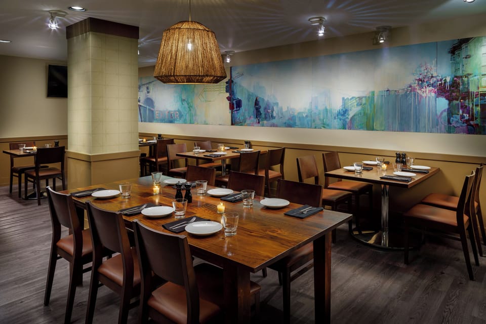 Gather for a relaxed meal in a warm, art-filled dining room.