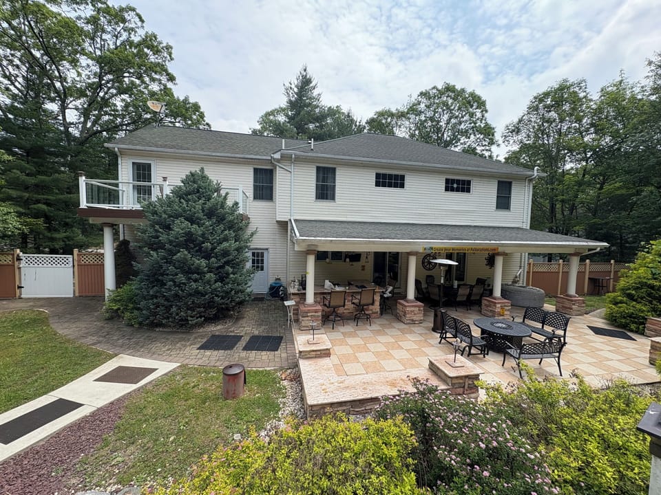Patio with griddle, dining set, fire pit and hot tub.