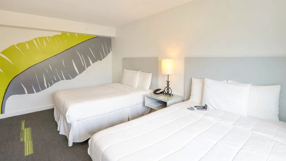 Drift off peacefully in soft bedding under warm bedside lighting.
