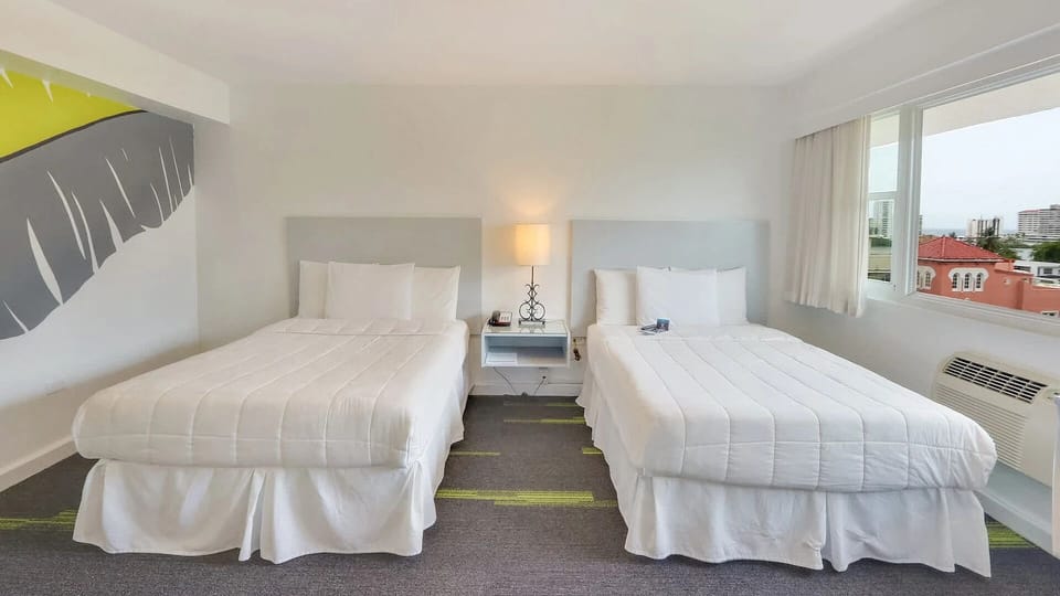 Stretch out on two plush beds beside a sunny window.