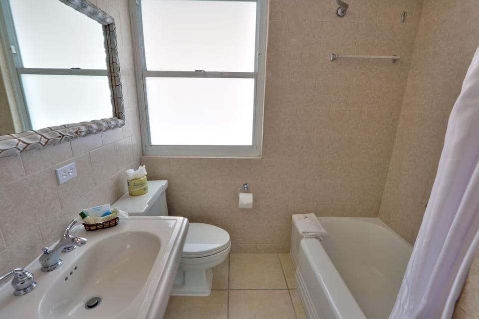 Refresh easily with a clean tub-shower and bright vanity.