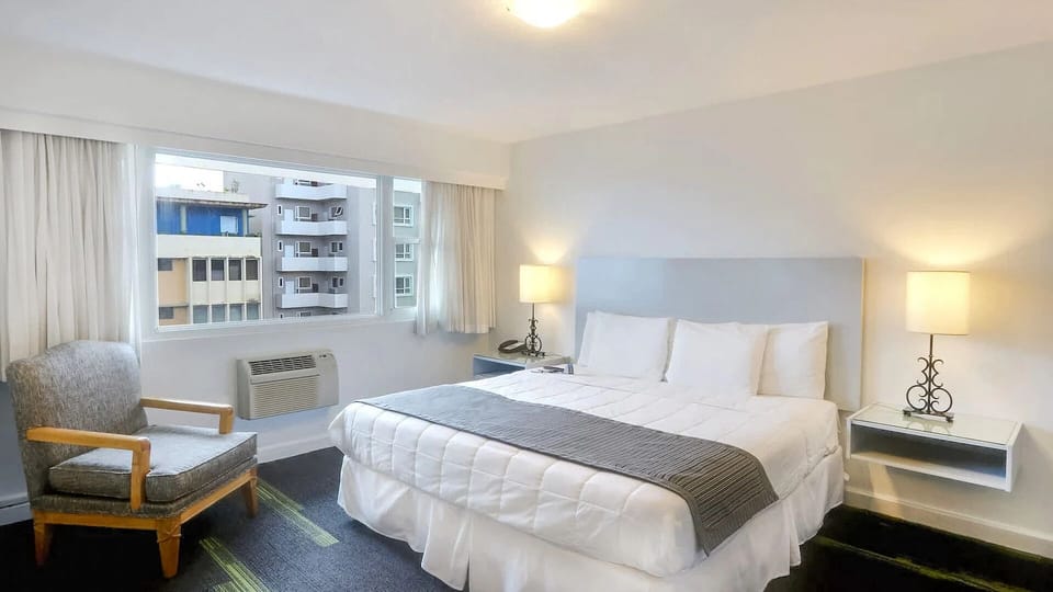 Recharge in a serene bedroom with soft lighting and seating.
