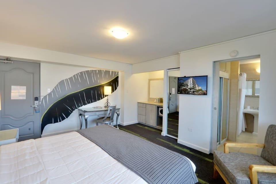 Settle in with TV, desk nook, and easy bathroom access.