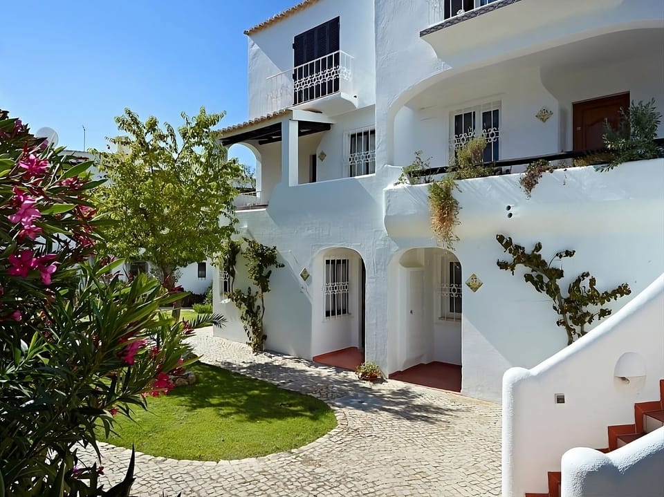 Arrive to whitewashed charm framed by lush, peaceful gardens