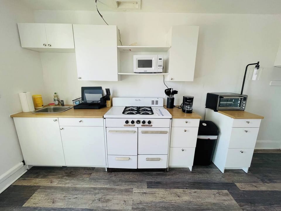 Step into a well-appointed kitchen designed for convenience. It includes a full-sized refrigerator, range, plenty of counter space for meal prep, and dining. You'll find generous storage in the cabinetry, making it easy to keep things organized.
