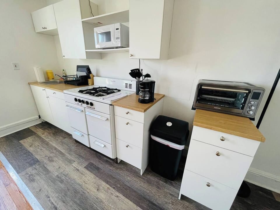 Step into a well-appointed kitchen designed for convenience. It includes a full-sized refrigerator, range, plenty of counter space for meal prep, and dining. You'll find generous storage in the cabinetry, making it easy to keep things organized.