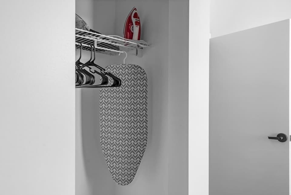 The large closet features an iron board & iron, extra towels, bed sheets, and toilet paper. You'll also find a vacuum for light messes and dryer sheets & laundry detergent for soft-feeling clothes every time!  Perfect for organizing your essentials.