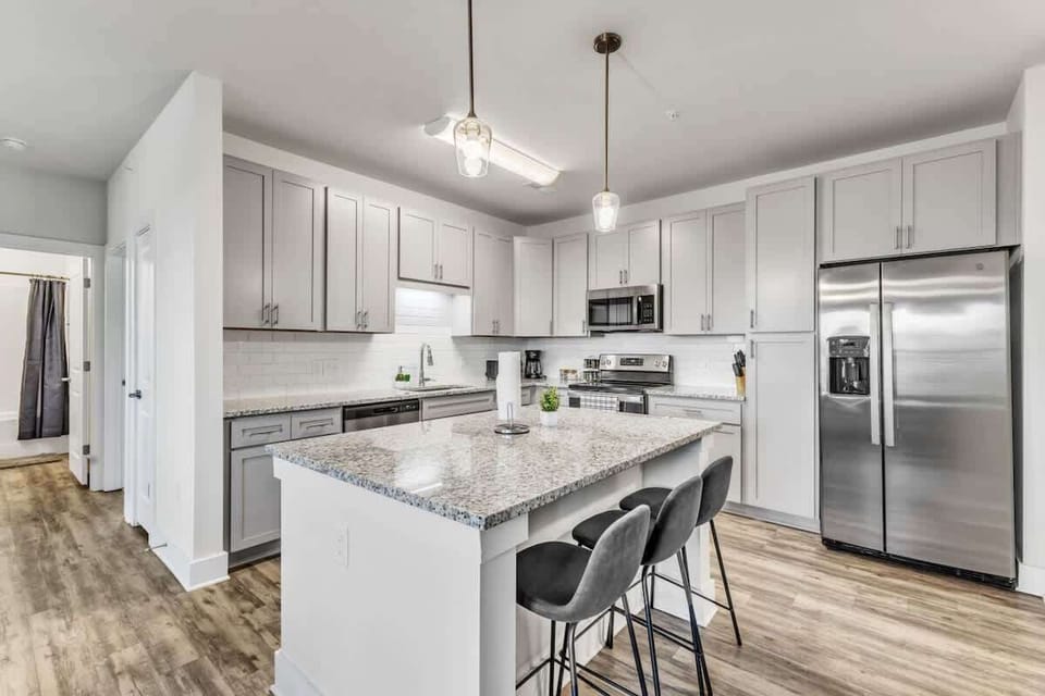 Experience the joy of cooking in this modern kitchen, where sleek countertops, state-of-the-art appliances, and plenty of storage make meal prep a breeze.
