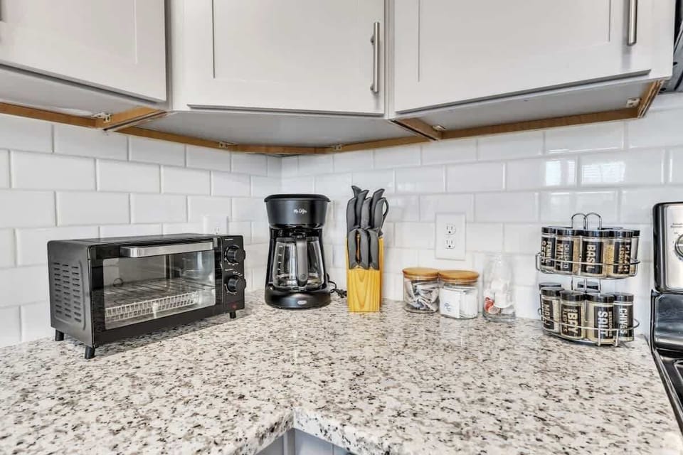 Experience the joy of cooking in this modern kitchen, where sleek countertops, state-of-the-art appliances, and plenty of storage make meal prep a breeze.