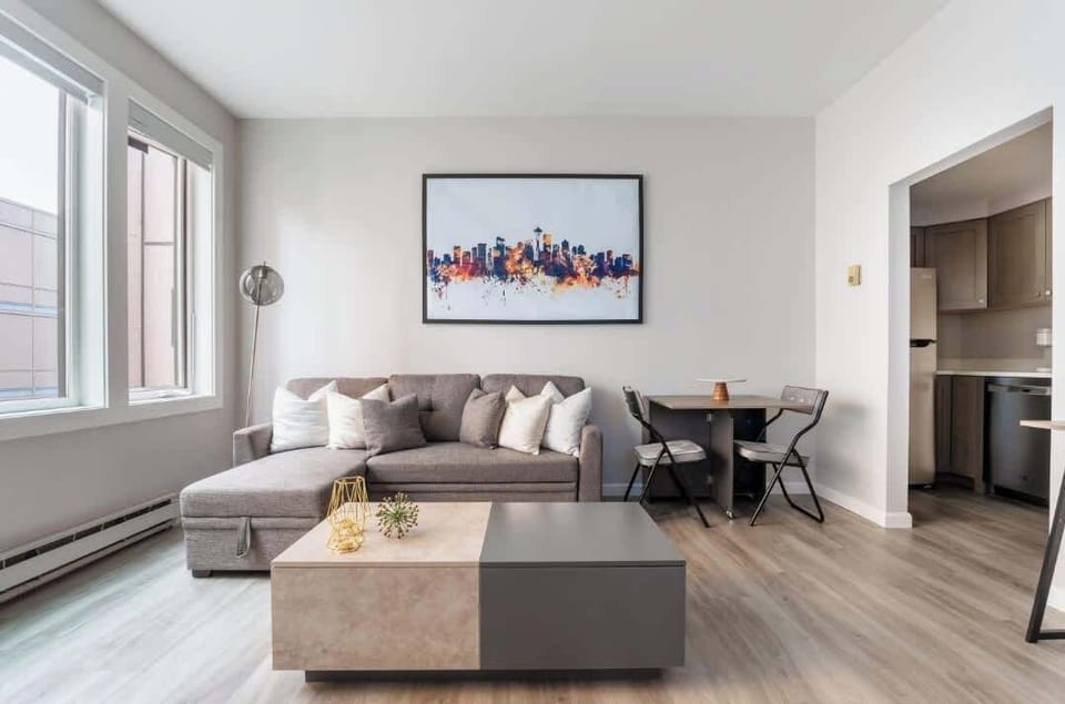 Couch, coffee table and dining table in living room.