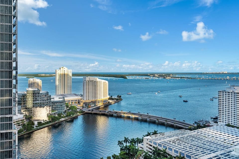 This is the breathtaking view from the master bedroom—overlooking Biscayne Bay, the Miami River, and the open ocean beyond. Watch yachts glide by and the sun rise over the water each morning from the comfort of your private retreat.