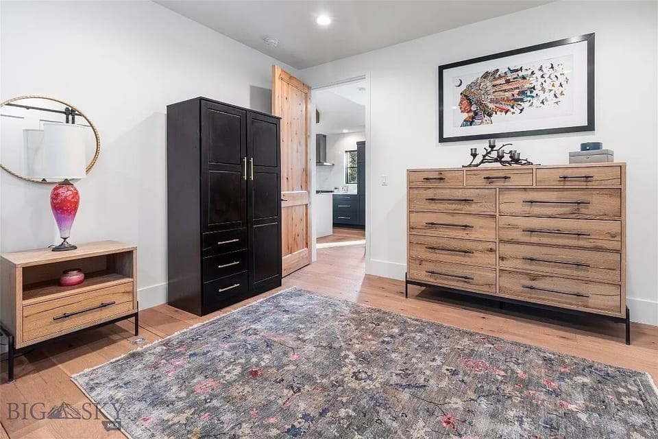 Lower level bedroom clothing storage options as well as hanging in the closet.