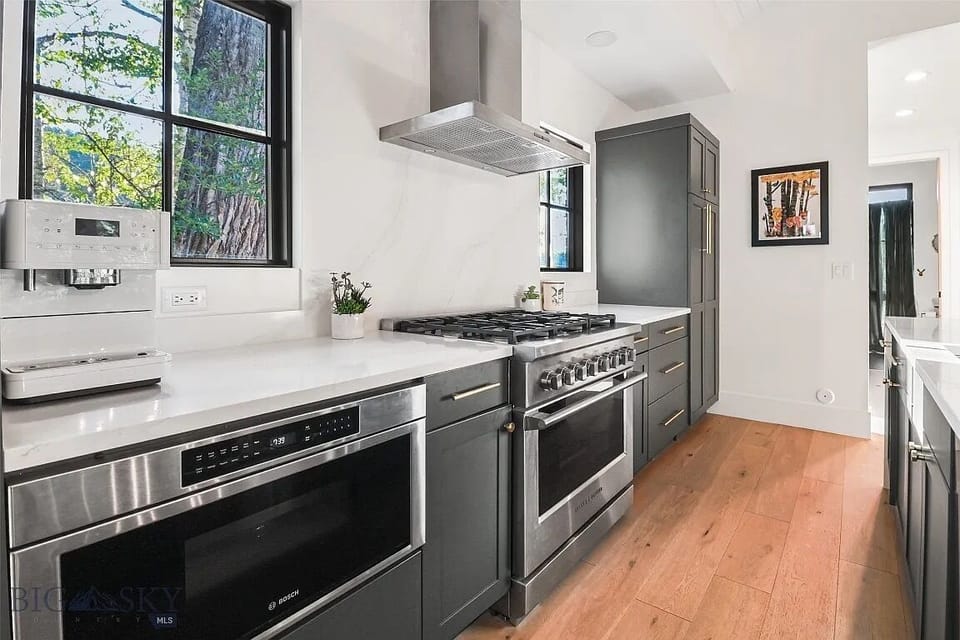 Fully equipped kitchen with stove, microwave, plenty of cabinet storage.