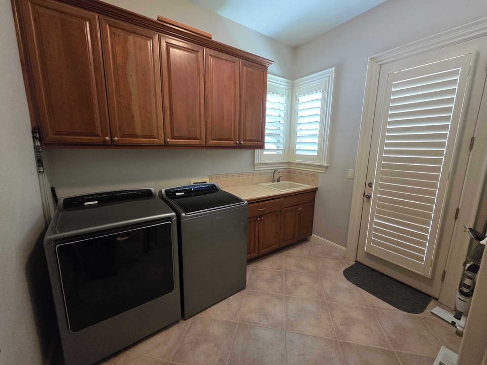 Dedicated laundry room with full-size washer and dryer for longer stays.