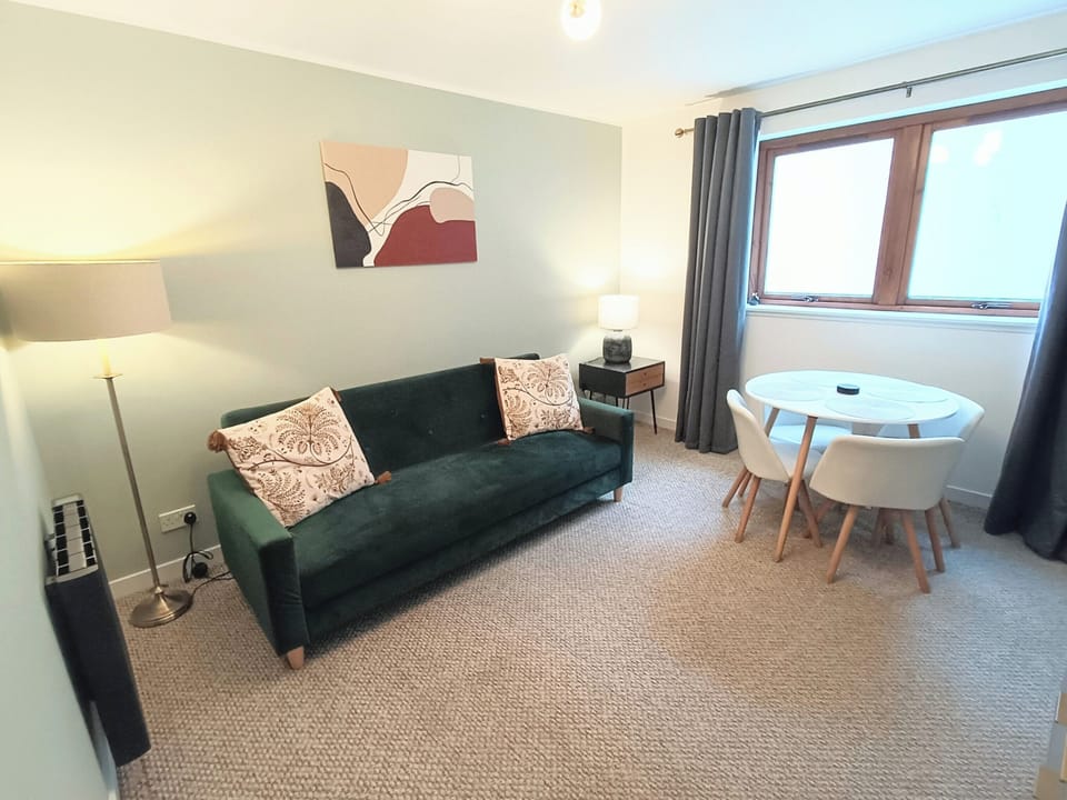 Living room with sofa bed and dining table 
