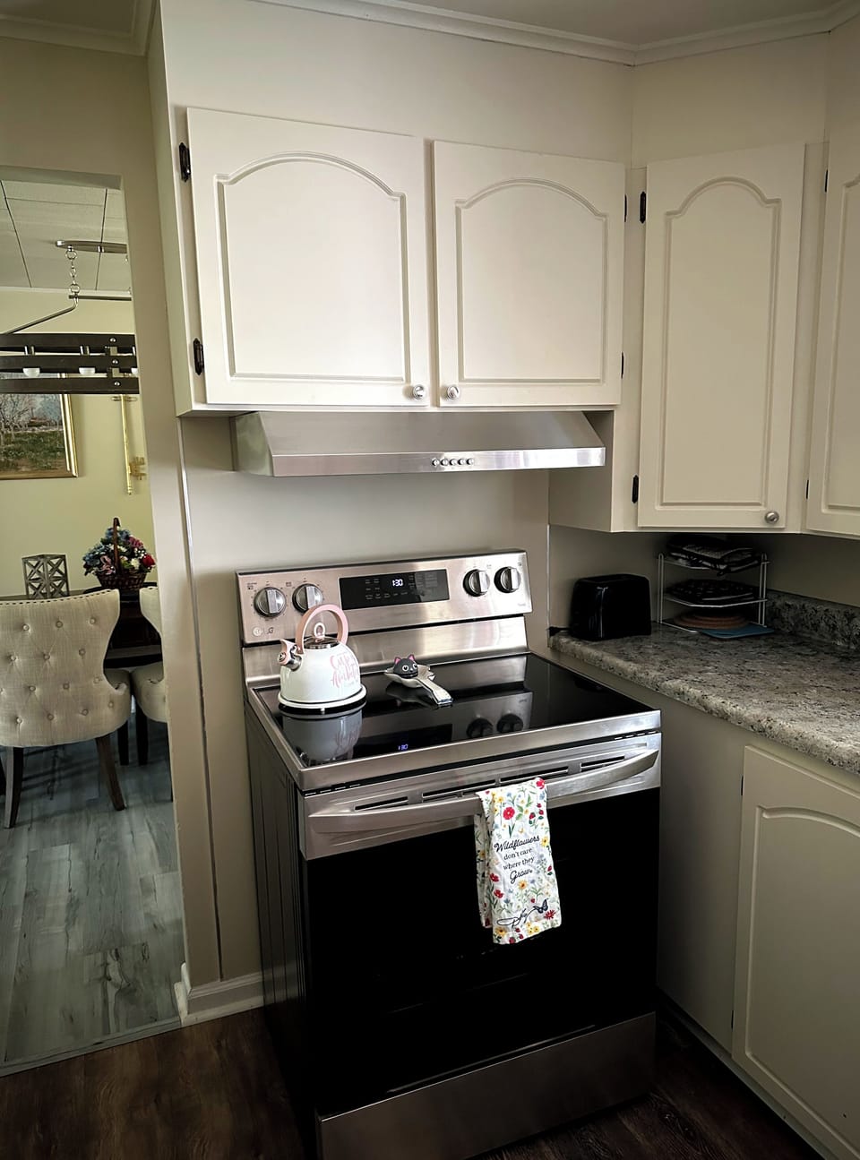 Our stainless steel  oven/stove  with overhead hood is perfect for making meals.
