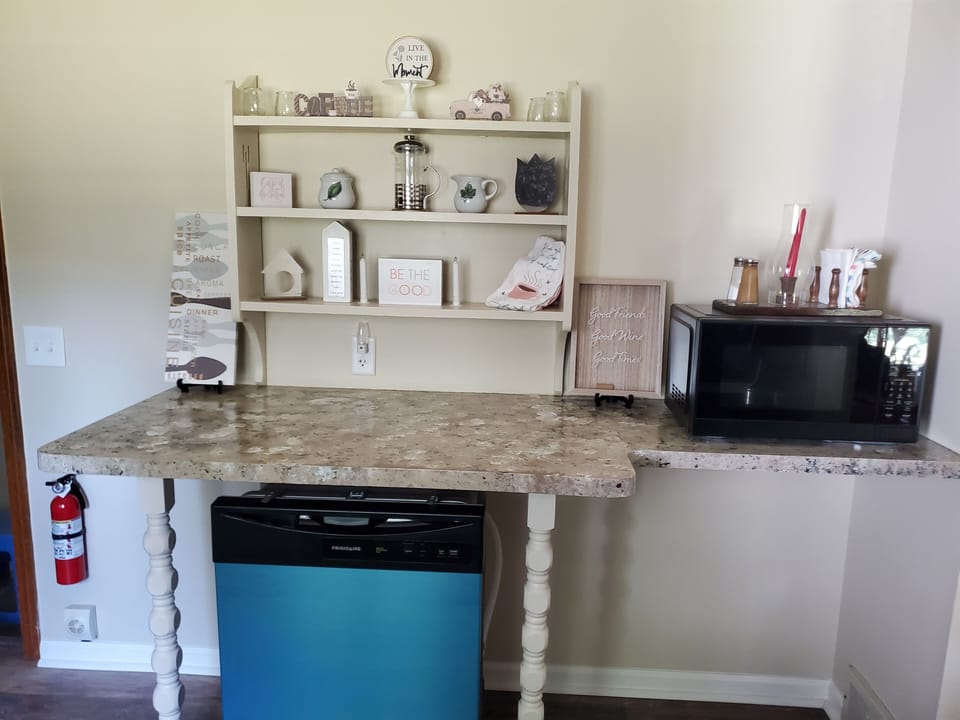 A microwave and newly installed dishwasher augments the kitchen. 