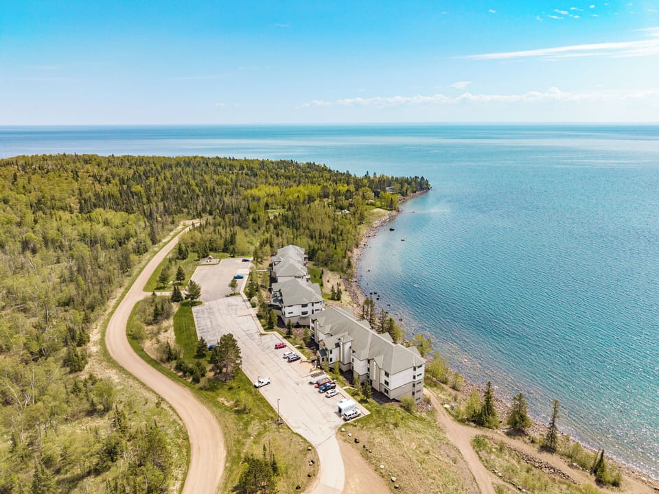 Lake Superior’s vastness meets cozy lakeside charm from above.
