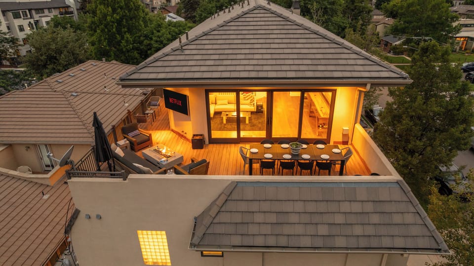 Slide open the doors and step into a fully integrated terrace experience—complete with cozy seating, a dining table, and a mounted TV for the ultimate entertainment zone.