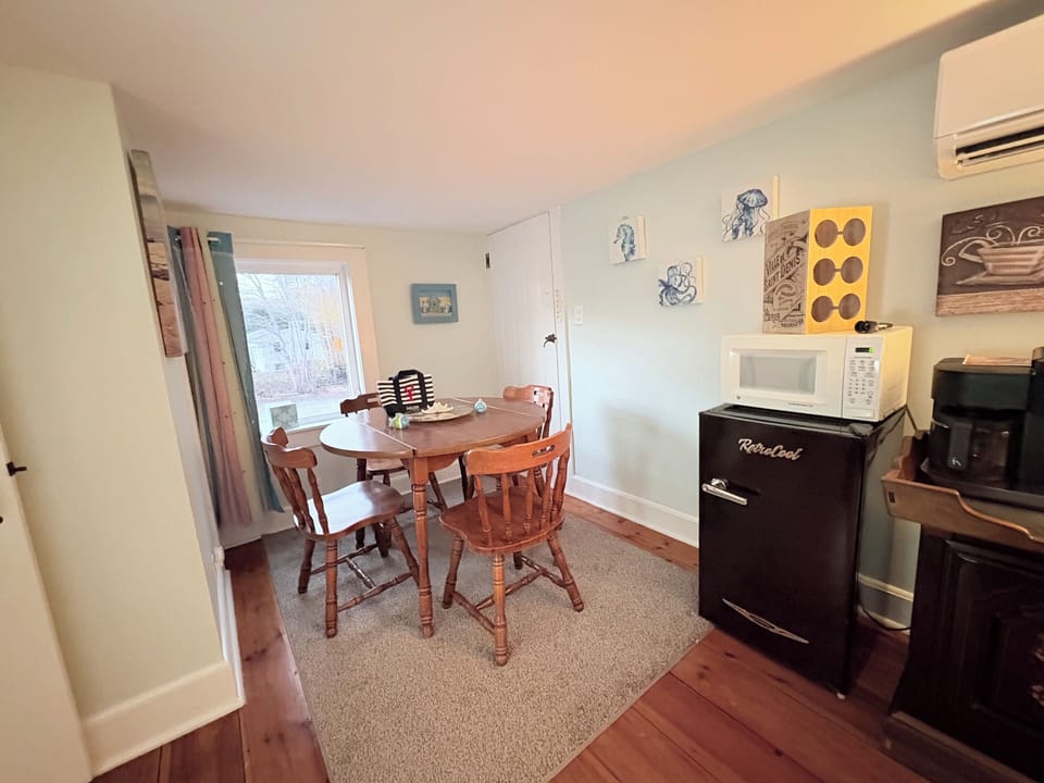 Spacious dining area for a family of four with a retro mini fridge and microwave