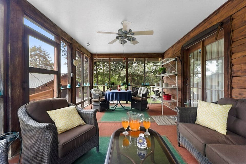 Wonderfully comfortable screened in porch with view of the woods