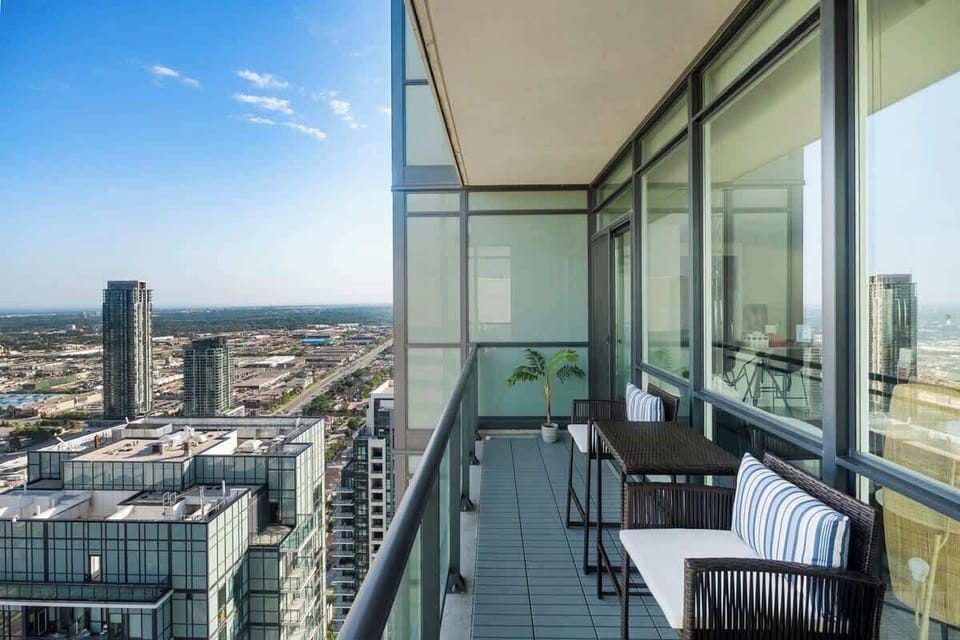 Unwind on your private penthouse balcony with expansive city views.