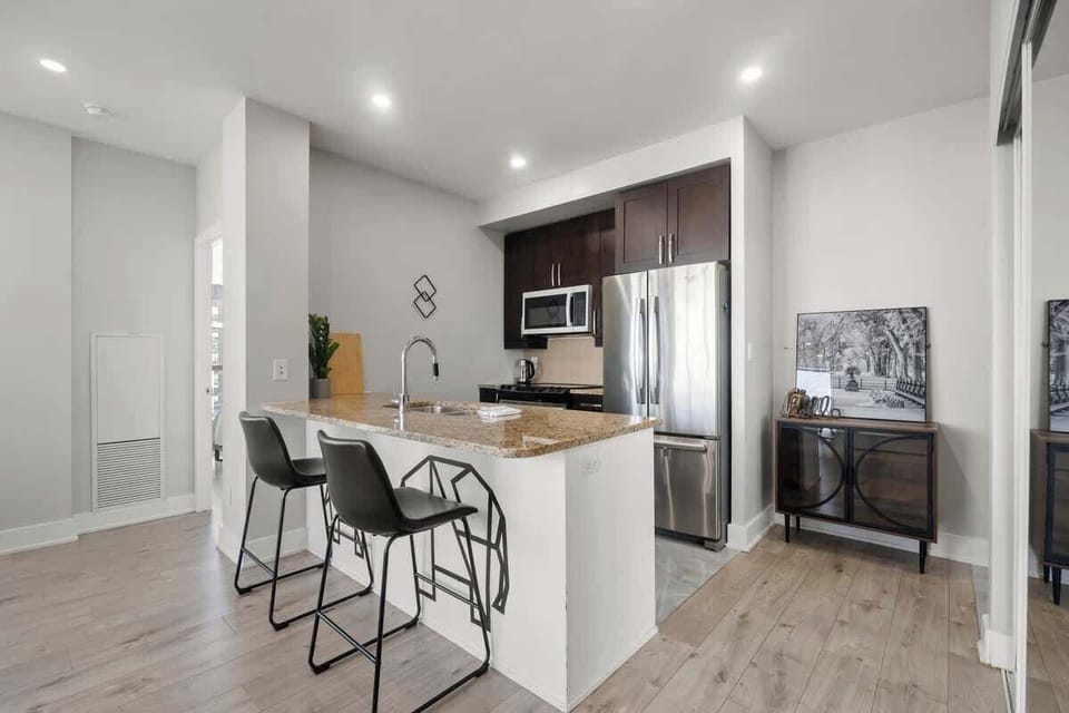 Prepare meals in this sleek, fully equipped kitchen with a breakfast bar.