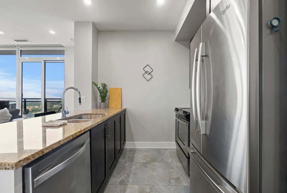 Enjoy cooking in this sleek, fully equipped kitchen with stunning city views.