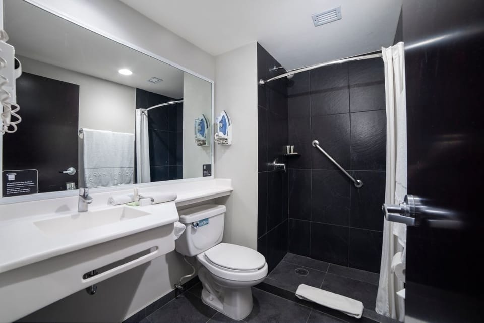 Step into a clean, modern shower with easy-access grab bar.