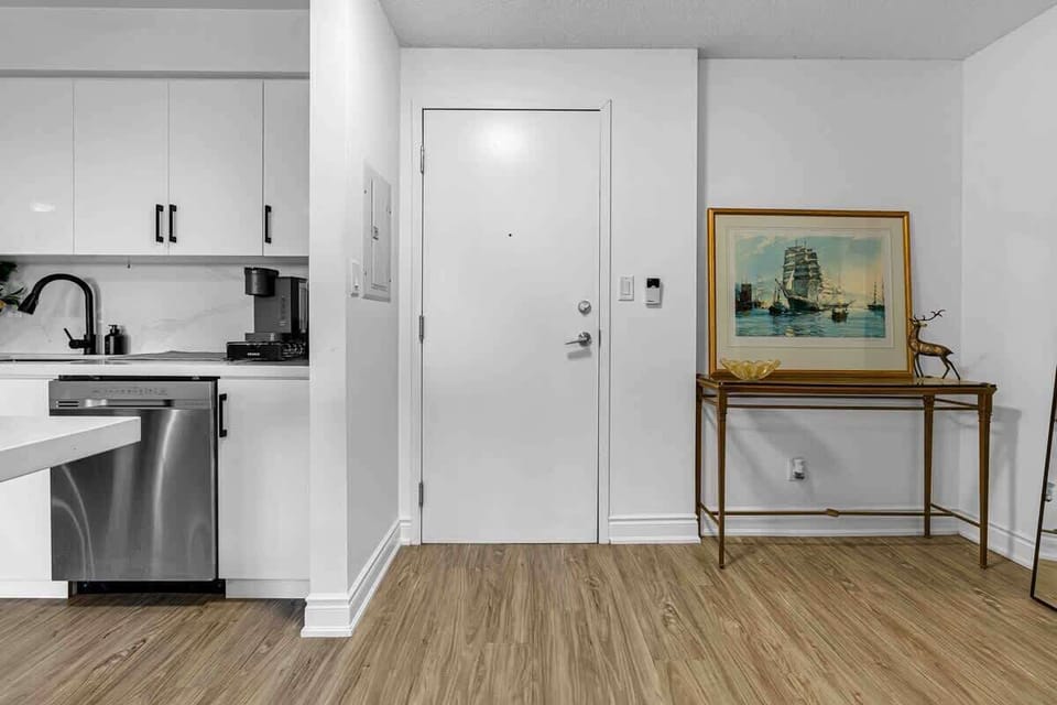 Sleek kitchen with dishwasher & inviting entryway. Your comfortable stay!