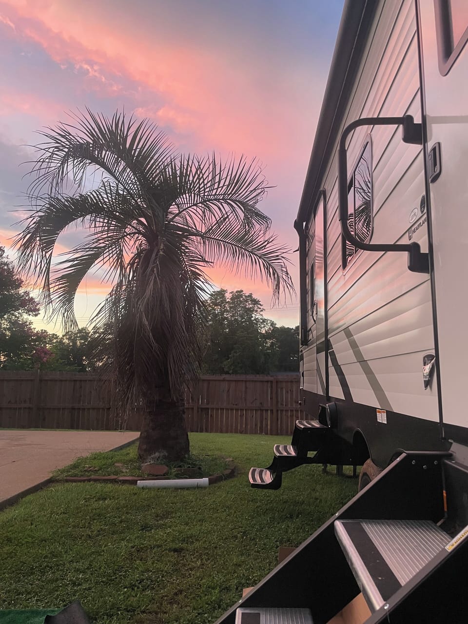 Spacious lot.  Camper if behind privacy fence with iron gate.