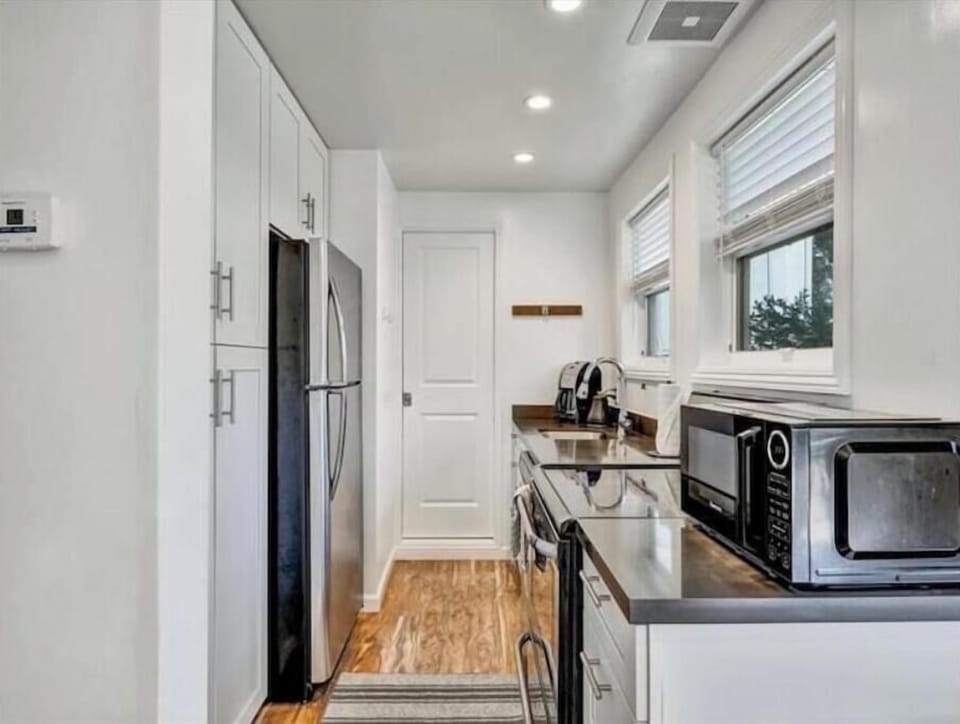 Galley kitchen equipped with essentials.