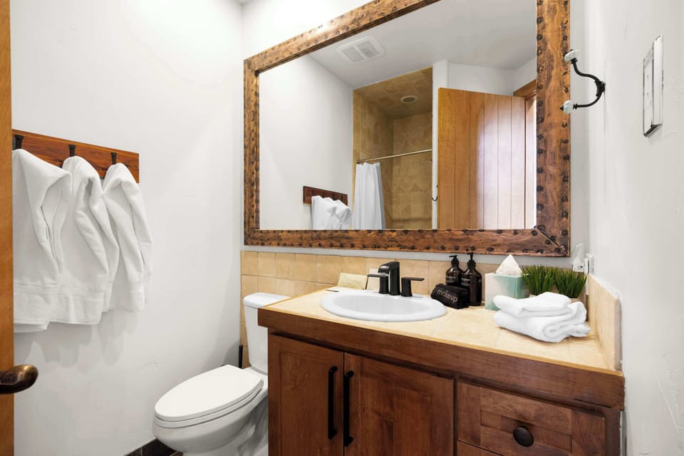 Bathroom 1 (upper floor): Full bathroom with walk-in shower, single sink