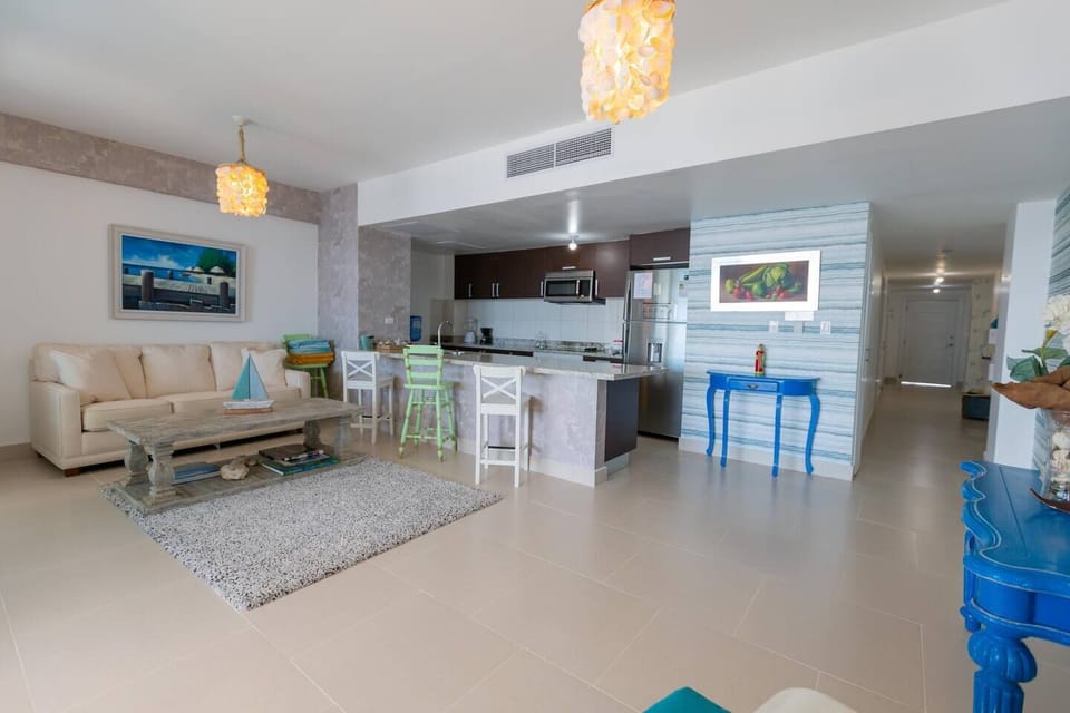 Spacious living room with A/C, Full Kitchen and balcony access.