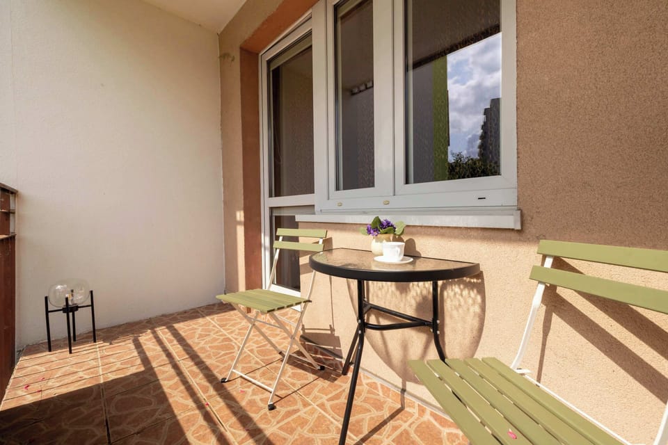 A bright balcony with a set of furniture is ideal for relaxing in the open air at any time of day.